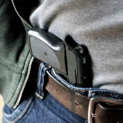 Person with concealed handgun in waistband, showing potential for gun charge in Texas