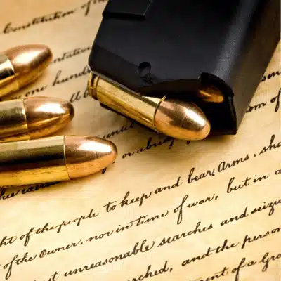 Bullets on top of Second Amendment text highlighting gun rights and gun charge in Texas context