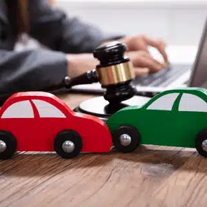 Gavel and toy cars symbolize courtroom outcome of a word vs word insurance claim
