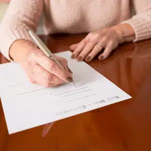 Woman signing a document raises questions about how long do you have to contest a will in Texas