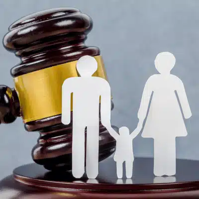 Paper cutout family in front of a gavel symbolizes intestate succession Texas family property division