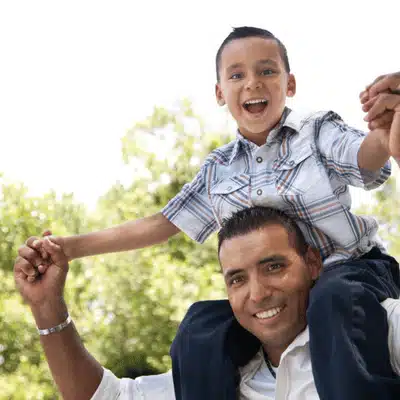 A joyful father carrying son on shoulders relates to intestate succession Texas family asset rights