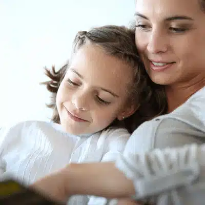 A mother and daughter reading together shows family concerns about intestate succession Texas estate rules