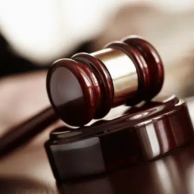 Close-up wooden gavel on sound block, representing courtroom focus on child support hearing questions today